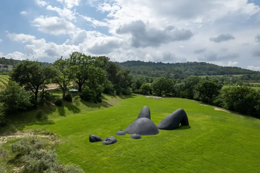Prune Nourry's Mater Earth, a monumental female body emerging from the meadow at Chateau La Coste, hills and vineyards beyond