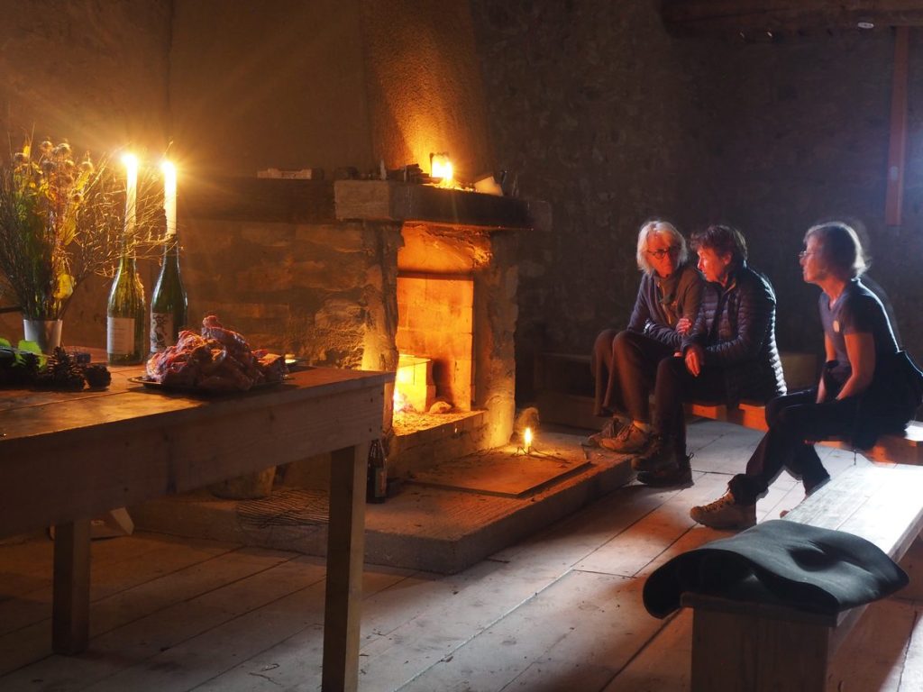 Candlelit evening inside Andy Goldsworthy's Refuge d'Art Ferme Belon, lamb chops waiting to be grilled over the fireplace