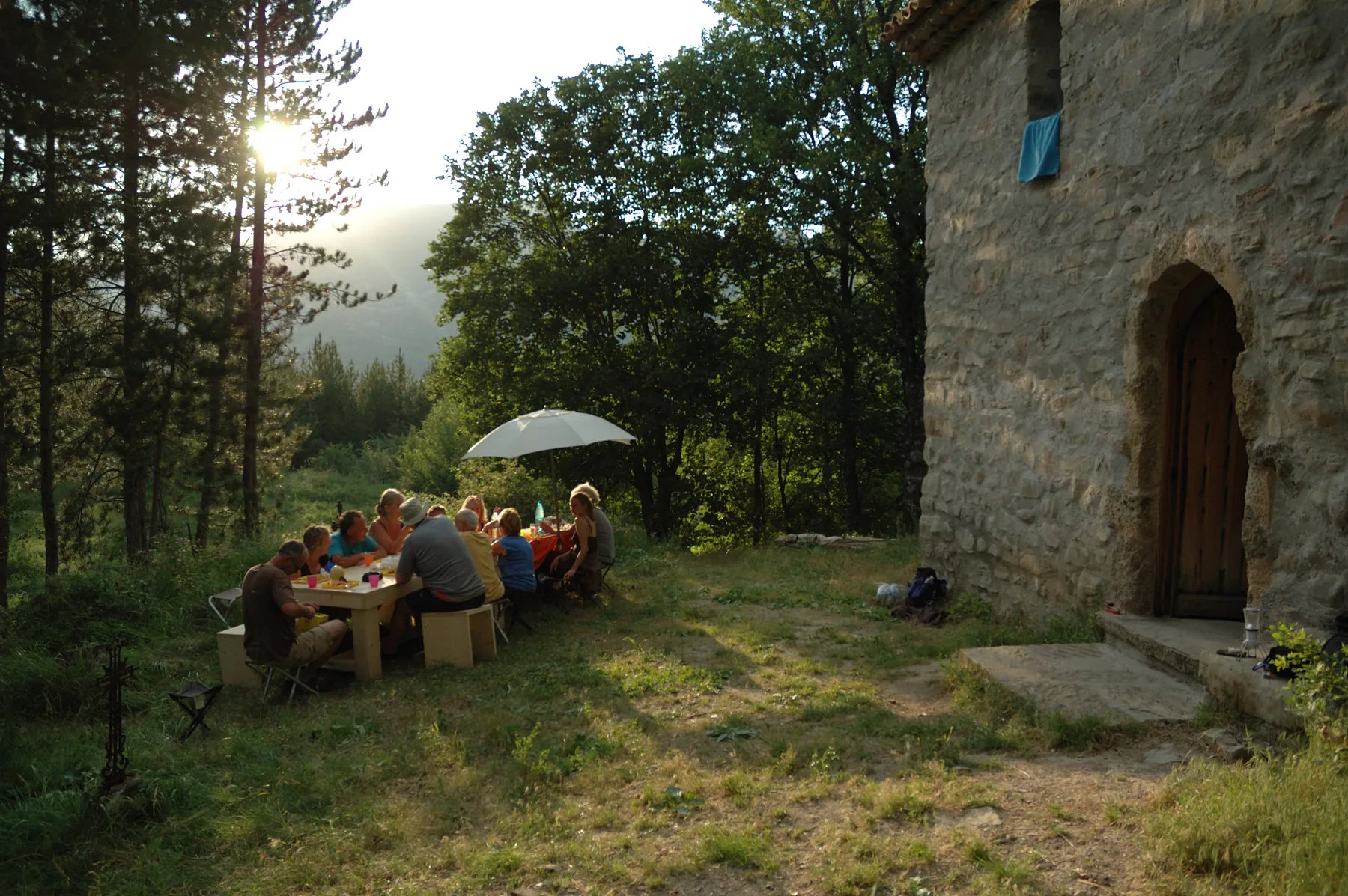 Gruppe beim Abendessen vor dem Refuge d'Art La Forest im Abendlicht, Haute-Provence